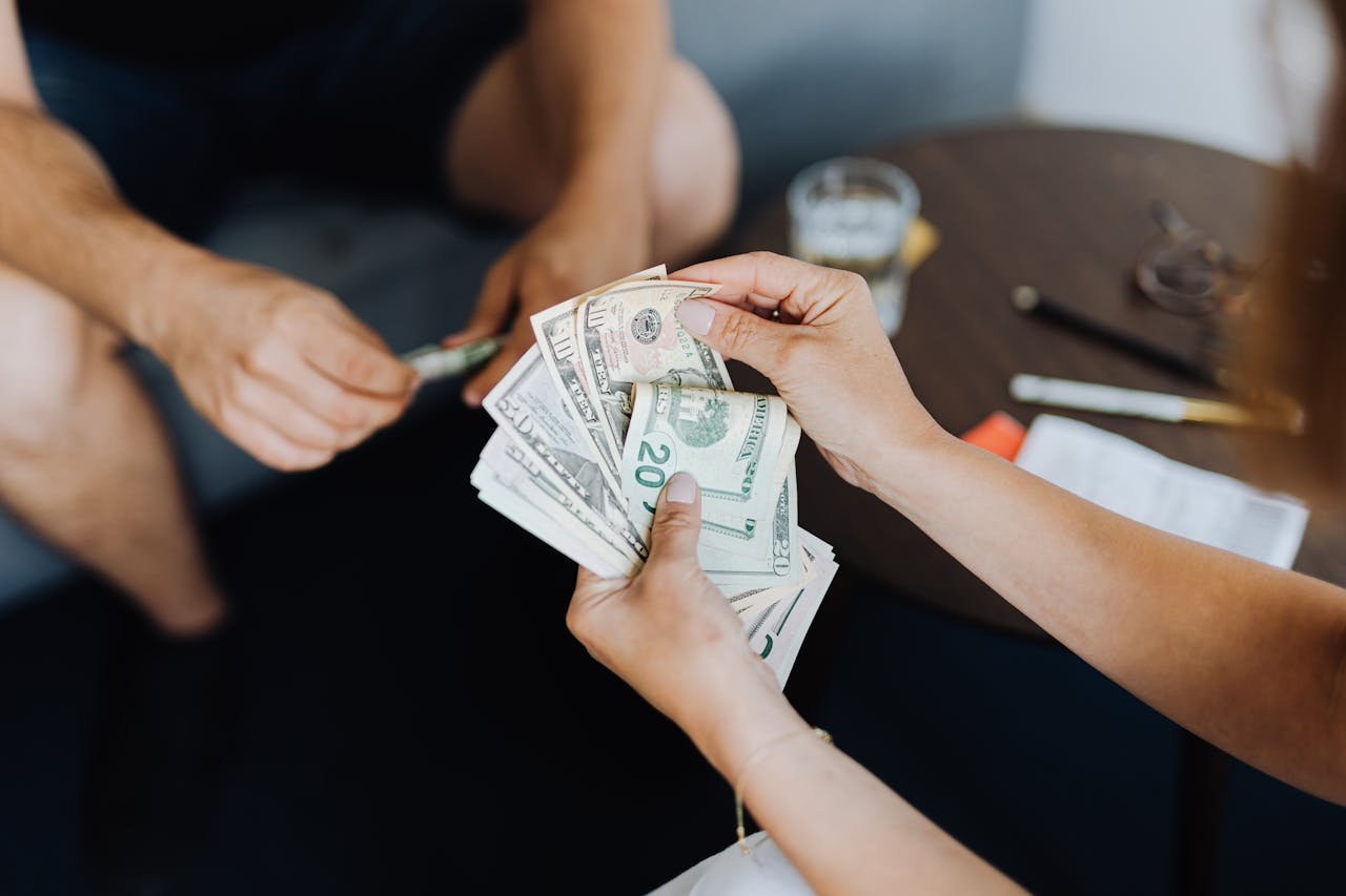 Mastering the First Impression: Your intriguing post title goes here Close-up of people handling and counting US dollar bills indoors.